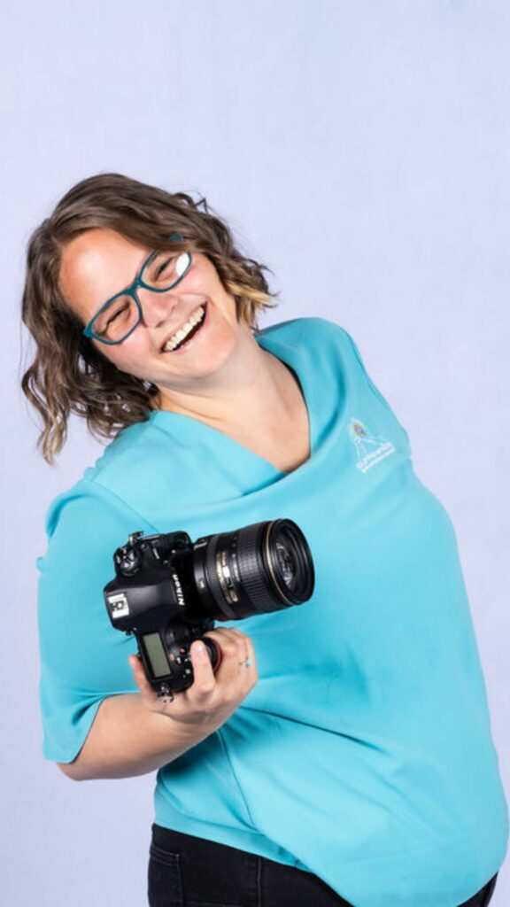 Photo of Ellie Clare owner of CLP Advertising & Photography Services with her Camera.