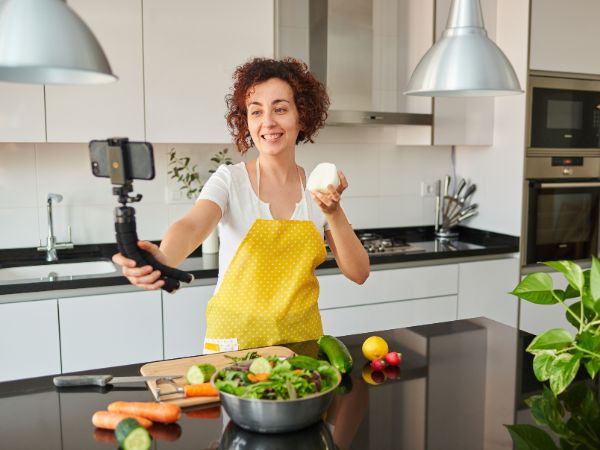 Photo of a lady creating videos for her business, and focusing on Video-First Marketing Strategies.