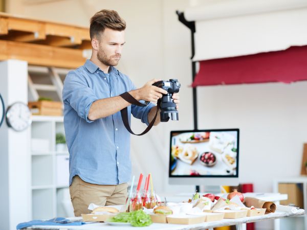 A professional photographer capturing a food arrangement in a studio, emphasising the importance of product photography.