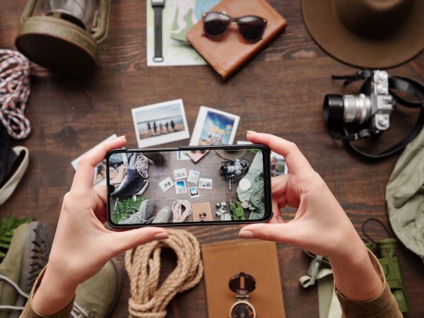 A smartphone capturing a top-down shot of travel gear, showcasing composition skills. 