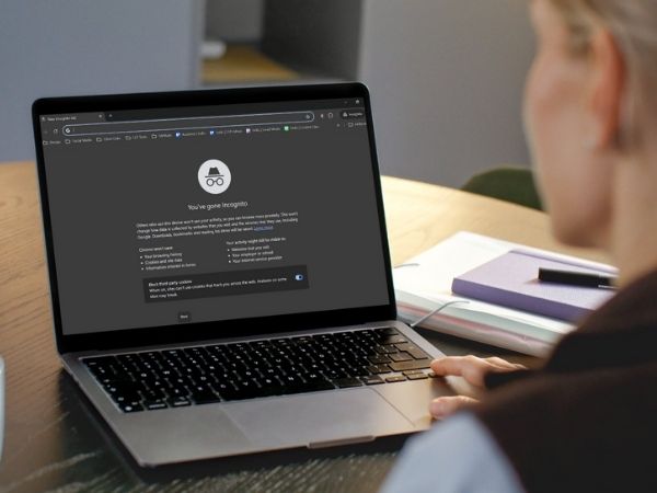 Woman using a laptop in incognito mode to conduct unbiased searches during a local SEO audit.