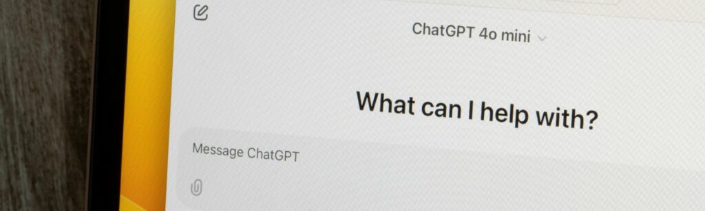 Close-up of a tablet screen showing the ChatGPT interface with the question “What can I help with?” symbolising AI-powered assistance and generative engine optimisation in digital healthcare marketing.