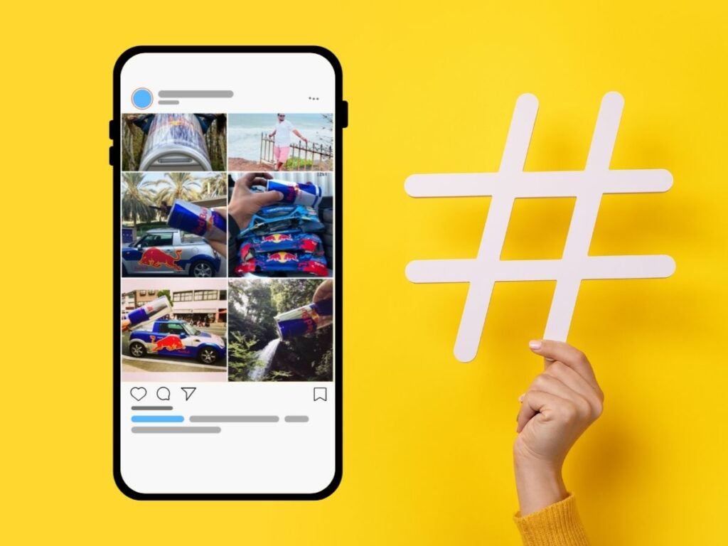 Photo of a smartphone screen showing Red Bull user-generated content with a large white hashtag symbol held against a bright yellow background.