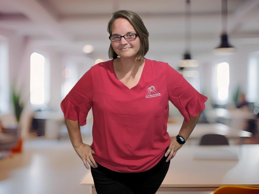 Ellie Clare smiling confidently in a coworking space, sharing her journey on how to stay focused as a neurodiverse entrepreneur.